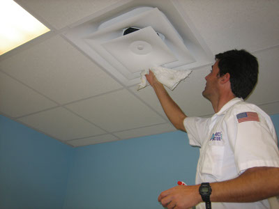 Person cleaning duct, About Duct Doctor
